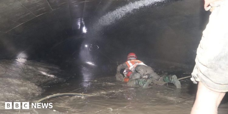 Nepal rescuers try to reach dozens trapped in tunnel after two pulled out alive